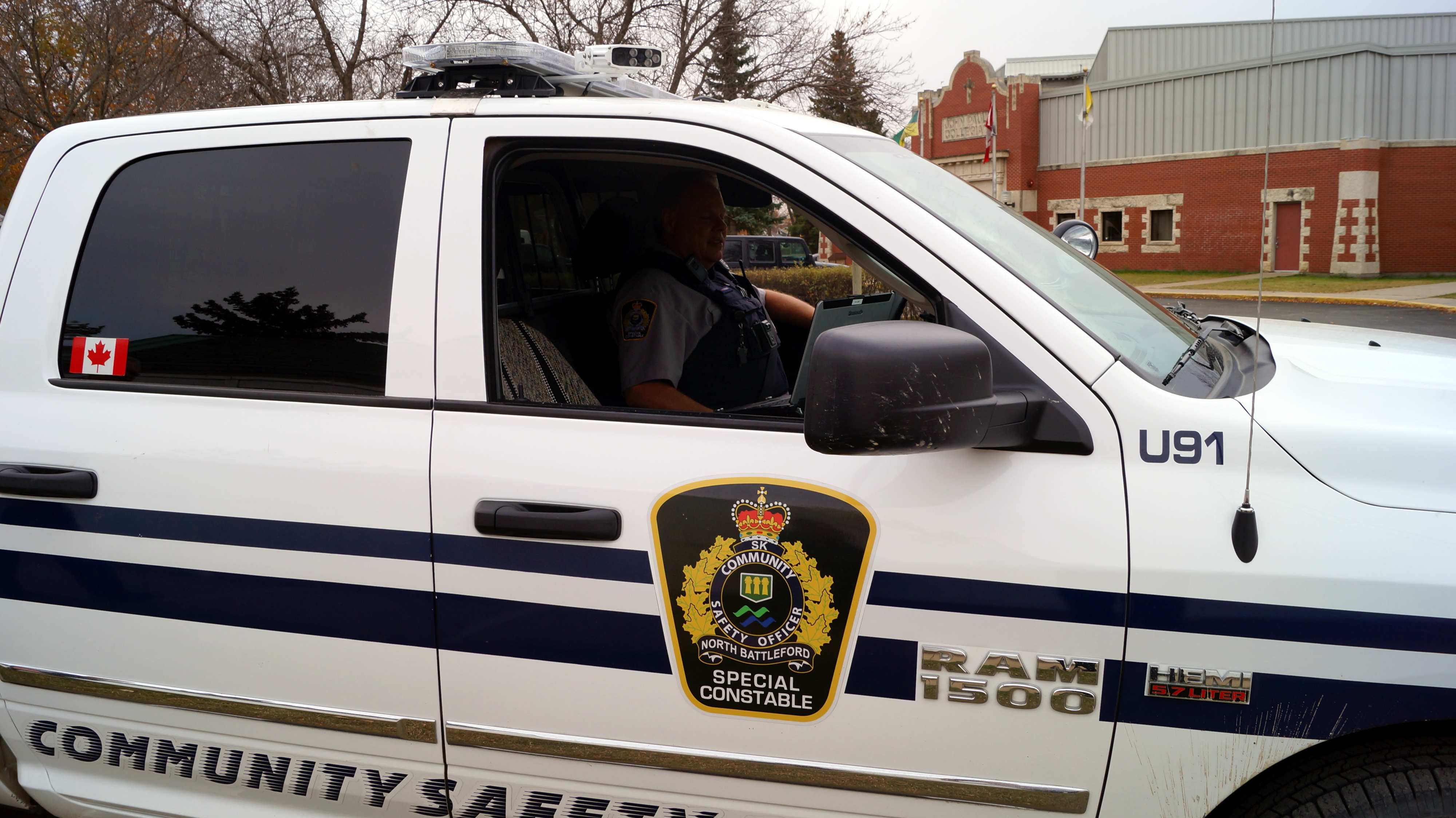 A Community Safety Officer truck in front of a building.