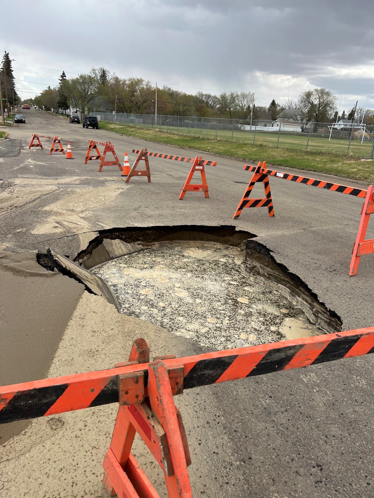 Image of Water main break causes large sinkhole on 16th Avenue