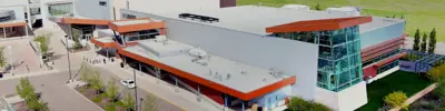 Aerial view of the Battlefords CO-OP Aquatic Centre, highlighting its modern design and green space.